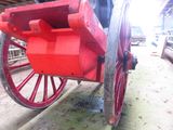 a red wagon that is sitting in a barn