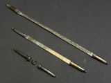 three different types of metal tools on a black surface