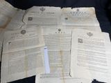 some old papers are piled on top of each other on a black surface