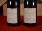 two bottles of wine that are sitting on a table