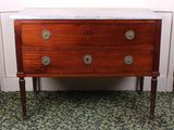 a wooden chest of drawers with marble top