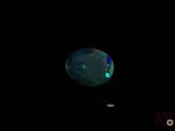 an image of a black background with a green and blue orb in the center