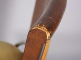 a close up of a wooden chair with an apple in the back