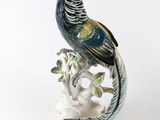 figurine en porcelaine représentant un oiseau perché sur une branche d'arbre