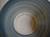 a close up of a blue and white bowl on a table