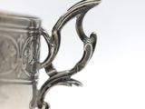 a silver cup that is sitting on a table