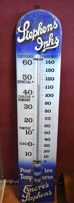 a blue and white thermometer on a wooden table