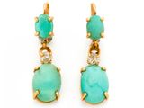 une paire de boucles d'oreilles en turquoise et diamants sur fond blanc