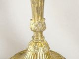 a gold candle holder on a white background