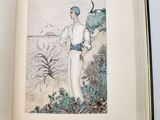 an open book with a drawing of a woman standing on a beach