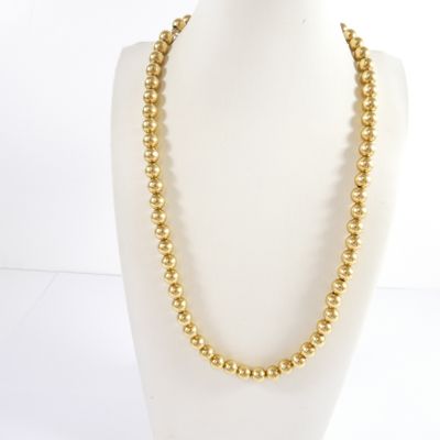 a gold beaded necklace on a mannequin mannequin mannequin mannequin mannequin mannequin mannequin mannequin mann