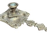 an image of a silver candle holder with a clock on it