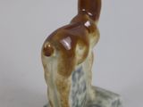 statue of a llama on a marble base on a white background