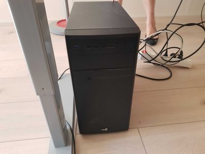 a black computer tower sitting on a hard wood floor