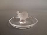 a glass plate with a napkin in it on a table