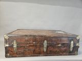 an old suitcase sitting on a white surface