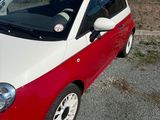 a small red and white car parked in a parking lot