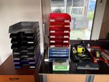 a desk with a lot of office supplies on top of it
