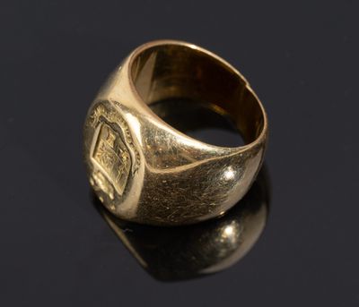 a close up of a gold ring on a black surface