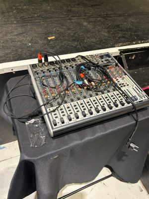 a table that has a keyboard and a mixer on it