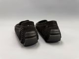 pair of black shoes on a white surface with a white background