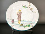 a plate with a picture of a man and a bird on it