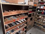 many boxes of screws and nuts on the shelves in the garage