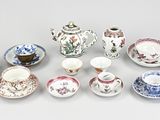 many different types of tea cups and saucers on the table