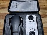 a black case with a remote control inside of it on a wooden floor