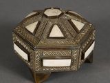 an antique silver and mother of pearl box on a stand