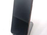 a cell phone that is sitting on top of a stand