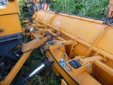 a large yellow machine that is sitting in the grass