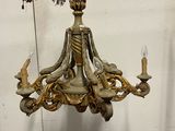a chandelier with a bird on top of it hanging from the ceiling