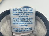 nike and the swooh name and stripe are on the back of a pair of shoes