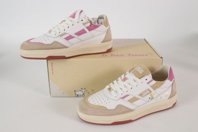 pair of white and pink sneakers sitting on top of a box