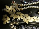 a black table with a bunch of jewelry on it