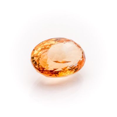 an orange sapphire stone on a white background