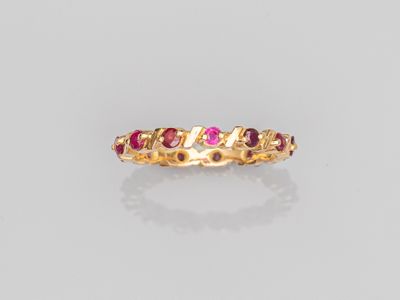 a gold ring with ruby stones