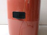 an orange air purifier sitting on a counter top