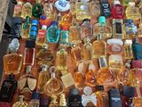 many bottles of perfume on a table with a price tag