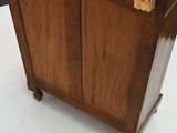 a wooden cabinet with a marble top on wheels