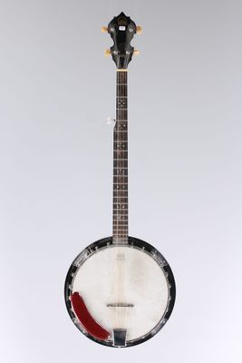 an old banjo with a red pickle on top of it