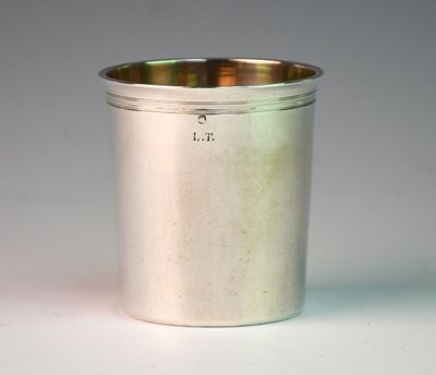 a silver cup that is sitting on a table
