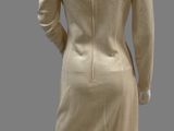 an image of a mannequin wearing a beige dress and jacket