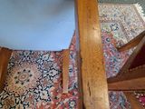a chair that is sitting on a rug on the floor