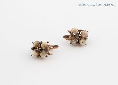 pair of silver and pearl flower earrings on a white surface