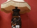 a lamp that is on a table with a lamp shade on it