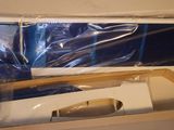 a box with a toothbrush in it that is wrapped in plastic