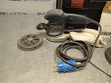 a picture of a corded sander and other tools on a table