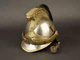 a gold helmet with a bird on top of it